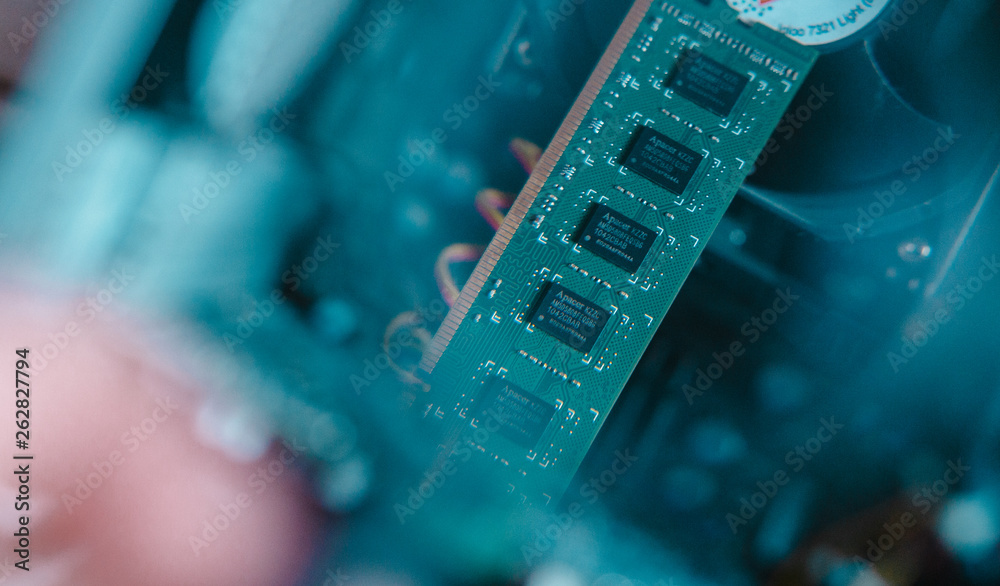 A craftsman who checks something with the magnifying glass on the micro schema in the computer