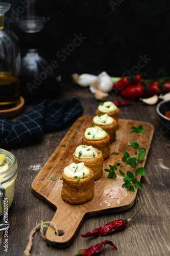 Gourmet dish, spanish appetizer - patatas bravas served on wooden cutting board