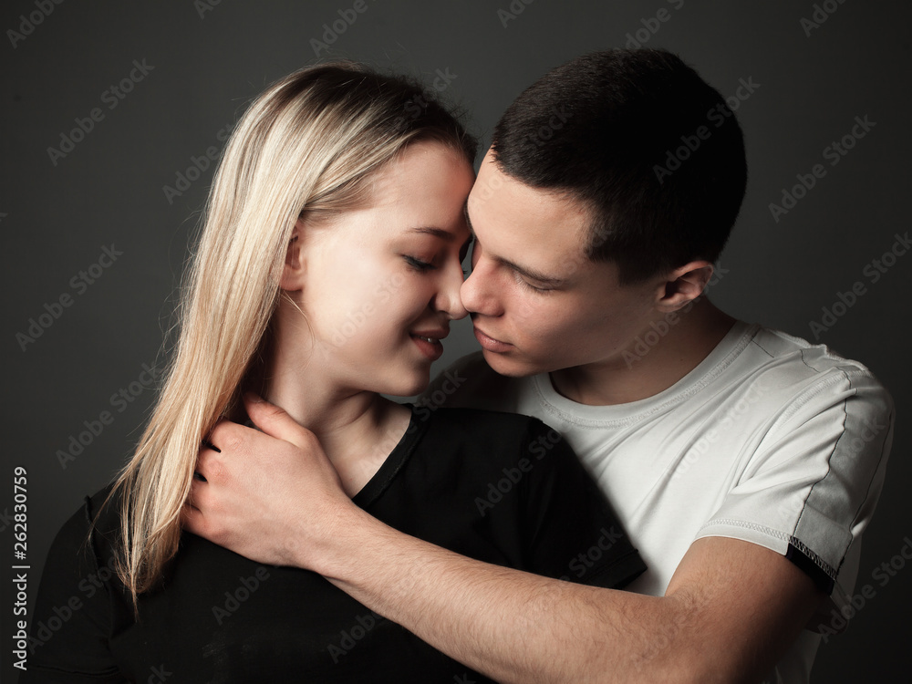 Portrait of young couple in love in studio. Portrait of young couple in love in studio.