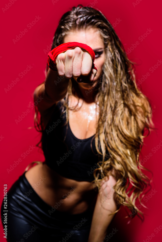Strength and motivation. Sporty woman during boxing exercise. Fit woman boxing. Powerful strong woman fighter boxer athlete MMA. Attractive female boxer training. Sport boxing concept. Selective focus