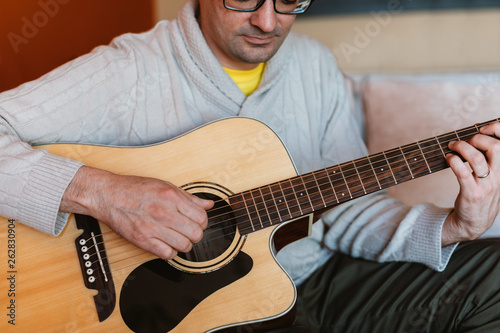 Man playing the guitar at home