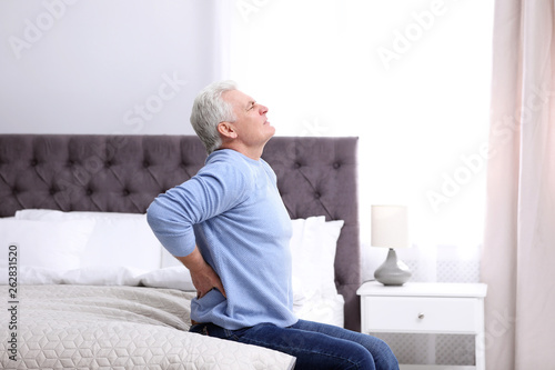 Senior man suffering from back pain at home © New Africa