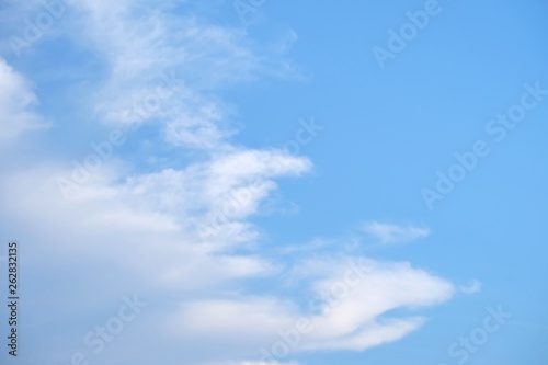 White fluffy clouds against blue sky in bright day for background backdrop 