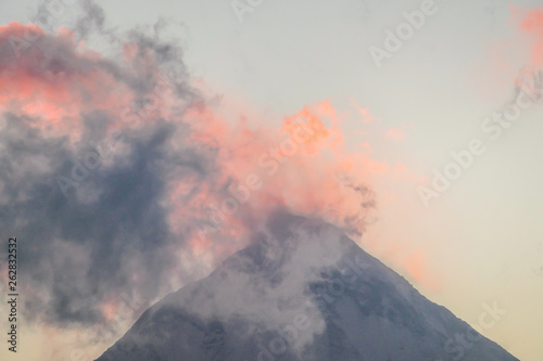 Peak of Annapurna I, Himalayas, Nepal. Top of the mountain covered with light clouds, in pink color. Soft colors of the sunrise. Beautiful spectacle in the nature. Cloud covering the top.