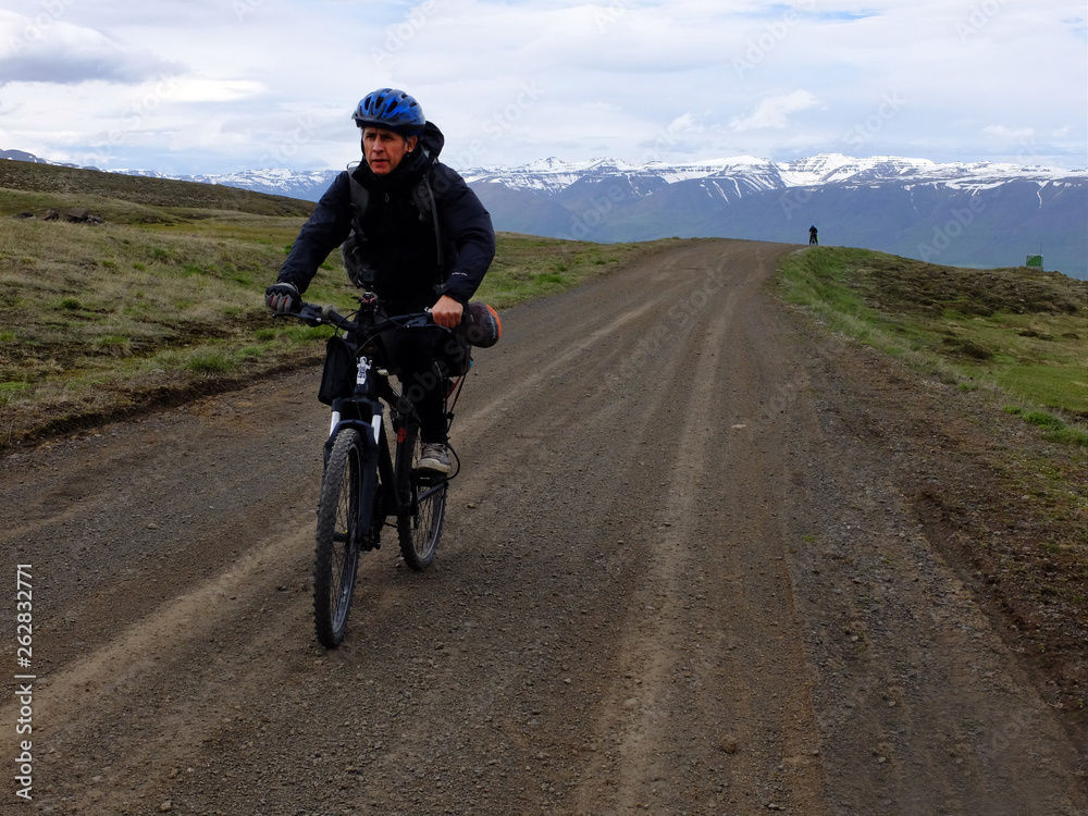 Fototapeta premium man riding a bike on country road