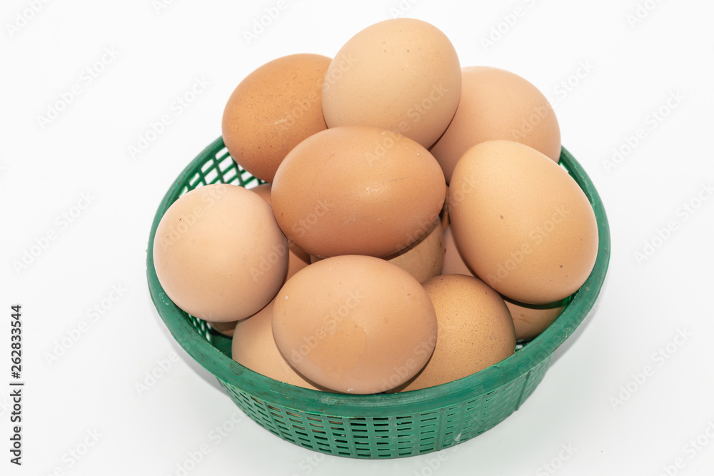 Close up eggs in a green basket isolate on white background. Select focus. Close up eggs in a green basket isolate on white background. Select focus.