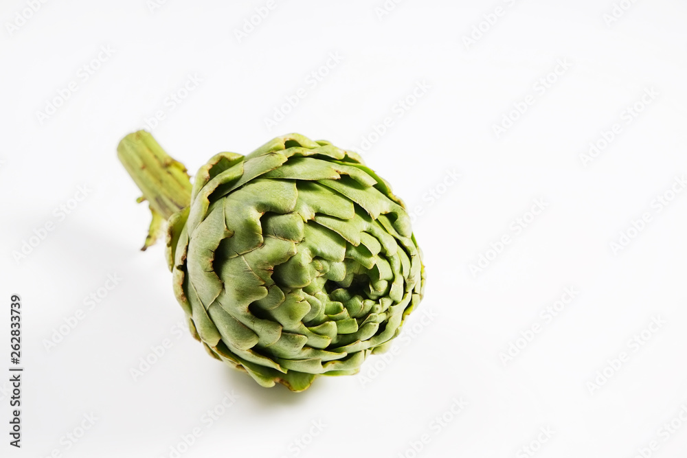 Obraz premium Fresh green Italian Artichoke isolated on white background. Organic local produce vegetable. Vegan diet. Clean eating concept. Close up, top view.