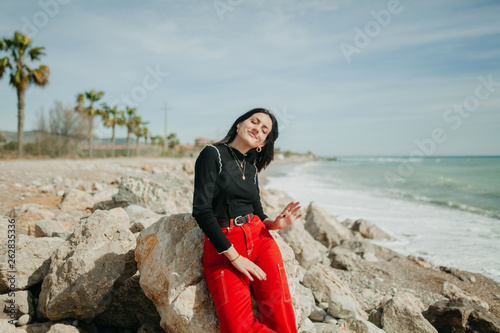 woman keeping closed eyes in calm sea while standing on sunny day photo