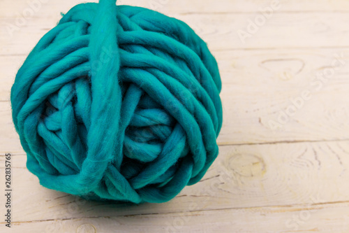 Merino wool yarn ball on white wooden background