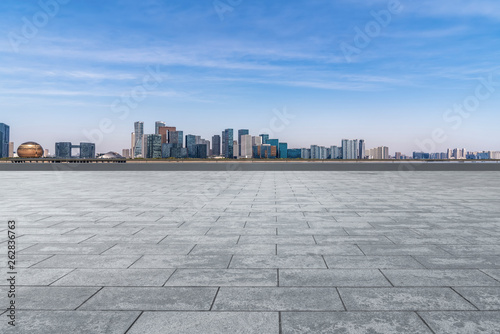 Empty square tiles and skyline of urban buildings.. © 昊 周