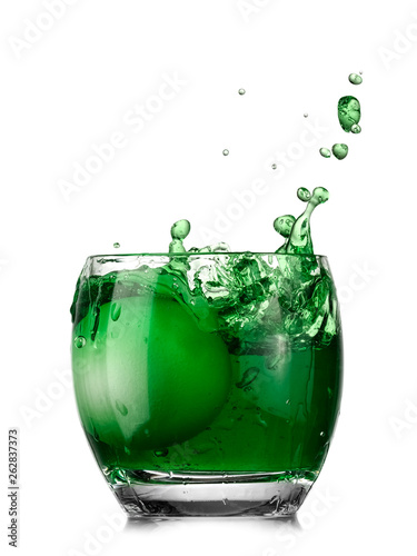 Painting green Easter egg in a glass