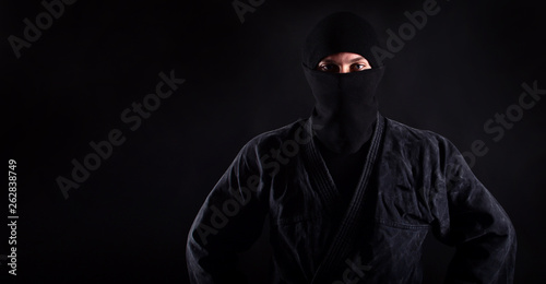 Portrait of ninja samurai with blue caucasian eyes.