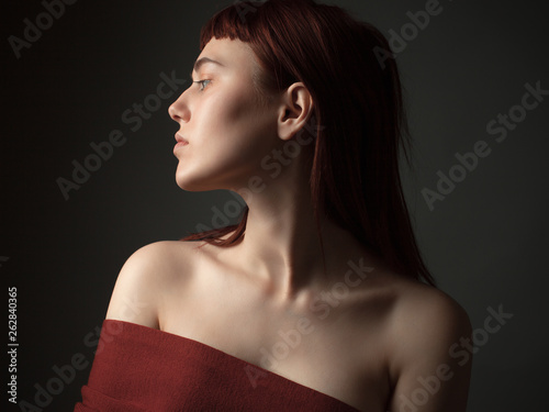 Portrait of a young woman with bare shoulders