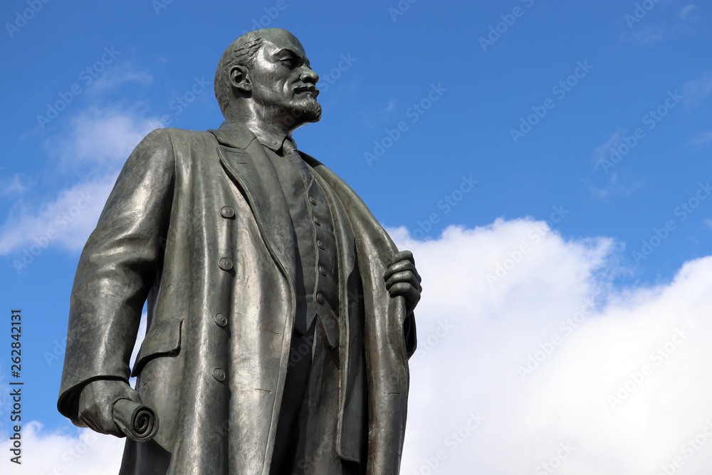 Monument to Lenin against blue sky with white clouds. Vladimir Ulyanov, leader of the russian revolution
