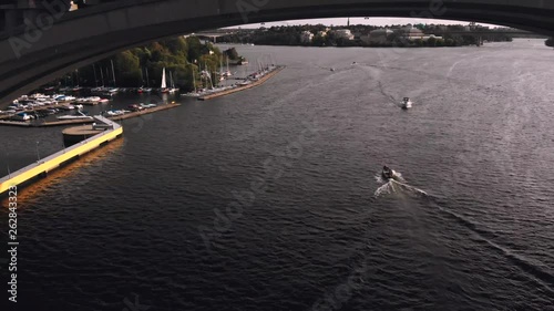 Norrström river in central Stockholm aerial footage near the bridge with boats photo