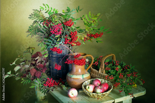 Still life with Rowan berries , viburnum , barberry and apples.Beautiful bouquet with red berries and apples .