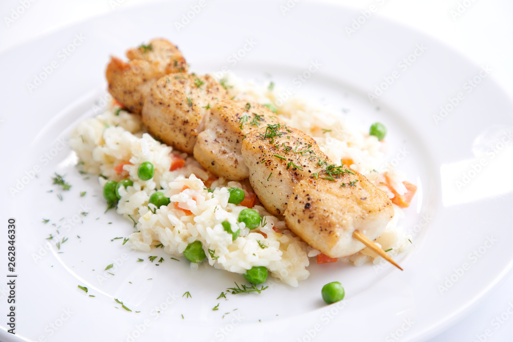 chicken kebab with rice and vegetables on the white background