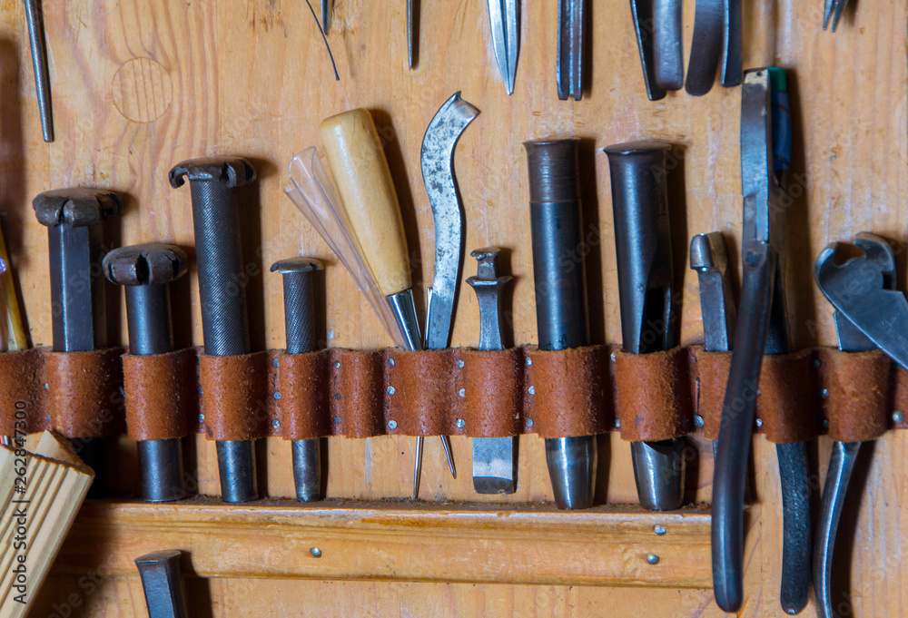 Leather tool on the wooden backgrounde Leather tool on the wooden backgrounde