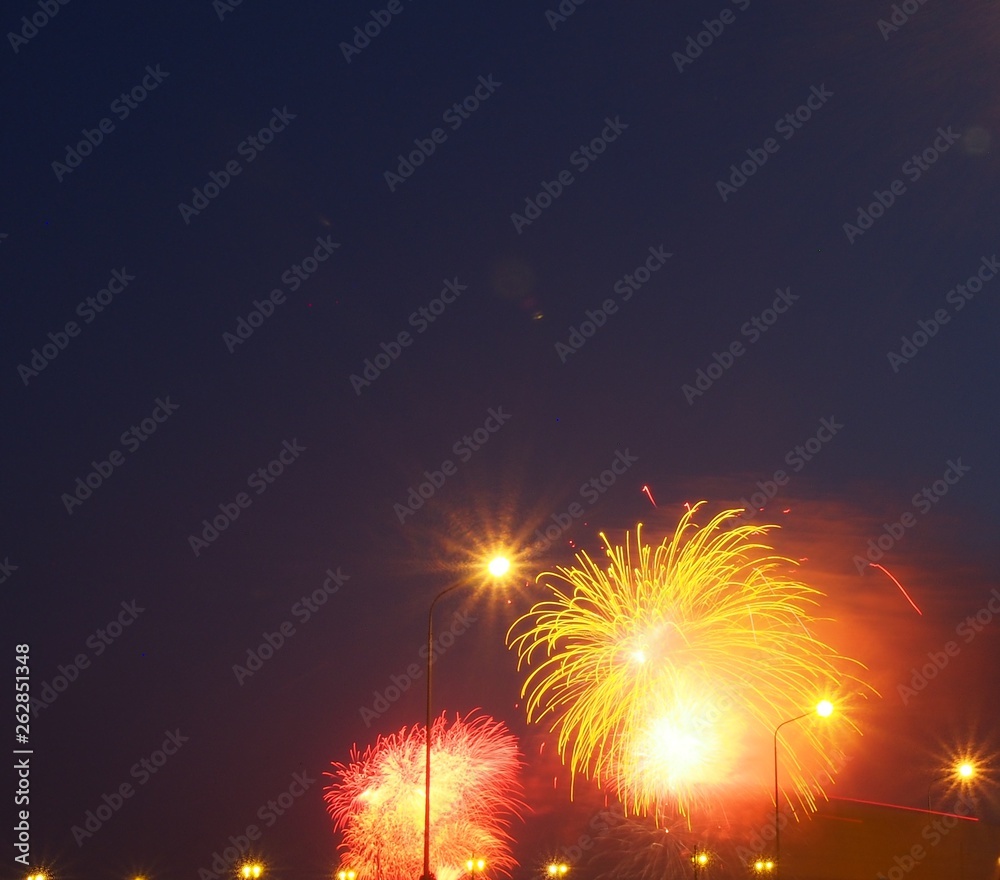 Colorful flashes of fireworks in the night sky. Fireworks.