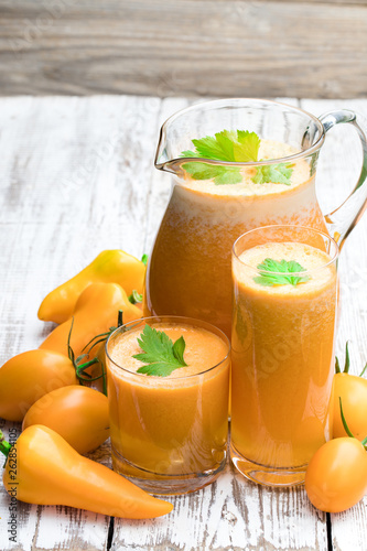 Fresh tomato juice made from the golden-yellow tomatoes in jar on the table