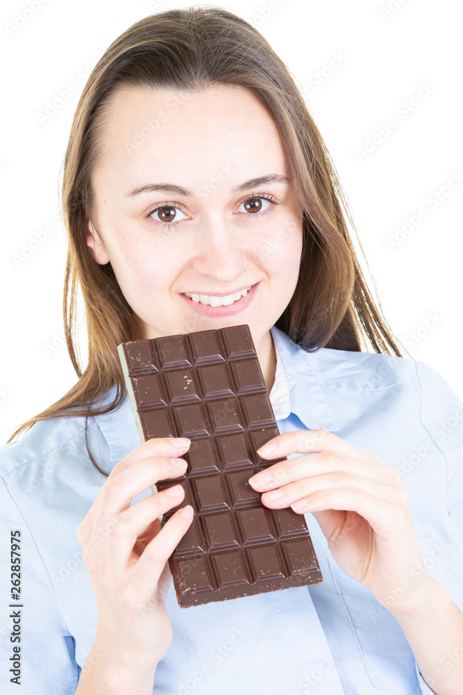 Beautiful woman smiling eating chocolate bar in isolated white background Beautiful woman smiling eating chocolate bar in isolated white background