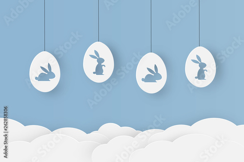 Happy easter paper cut with bunny shaped in eggs that looks cute on blue sky background