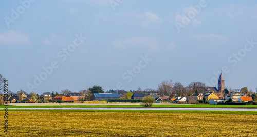 skyline of the village of Rucphen, a small rural village in North Brabant, The Netherlands, view from the pasture photo