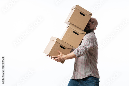 Young man carrying and dropping his stack of moving boxes © sutulastock