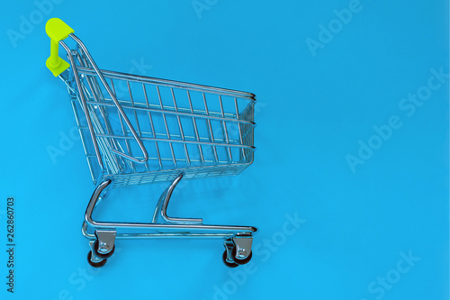 Small toy pushcart on a blue background