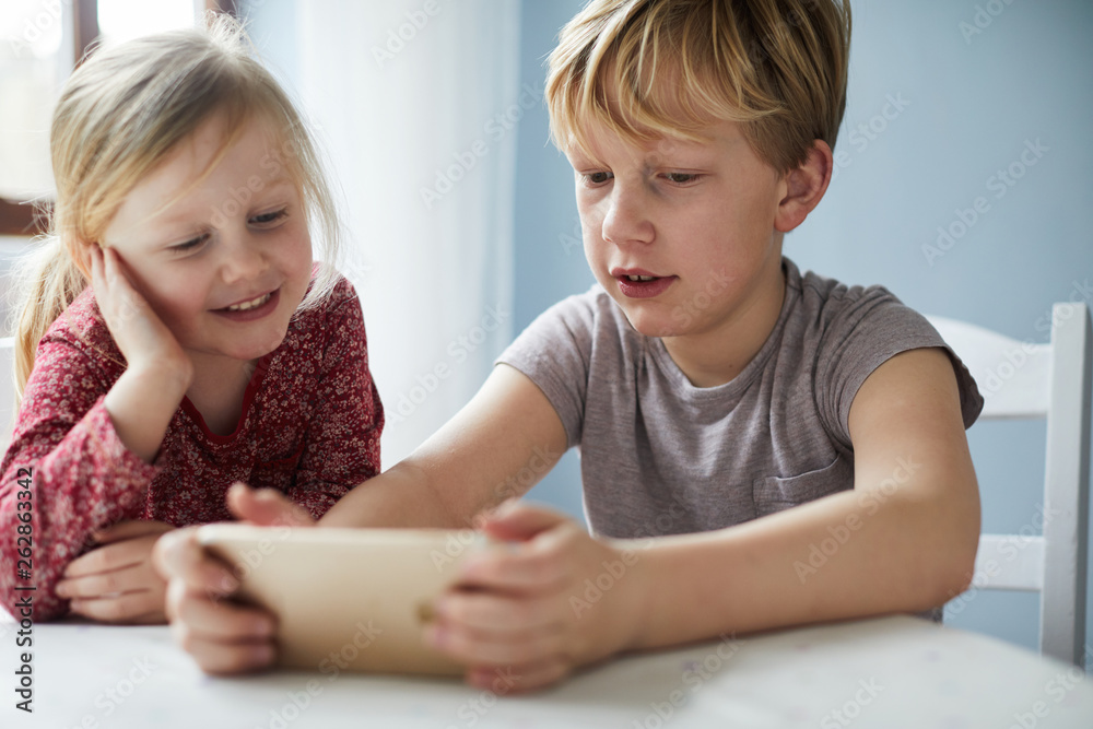 Children playing on smartphone together Children playing on smartphone together