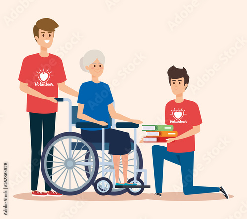 boys volunteers with old woman and books donation