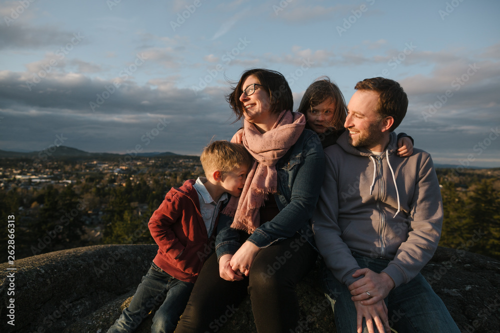 Fun family of four spending time together in nature