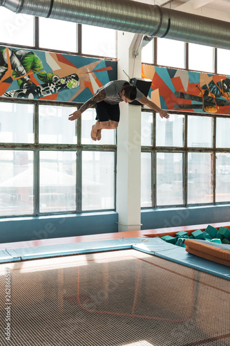 Athlete jumping high above tramp