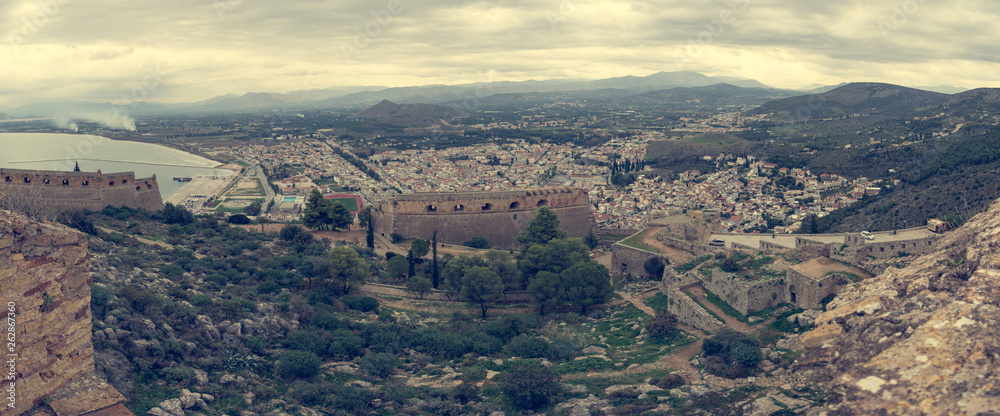Panoramic view of greek coastal town with ancient ruins.