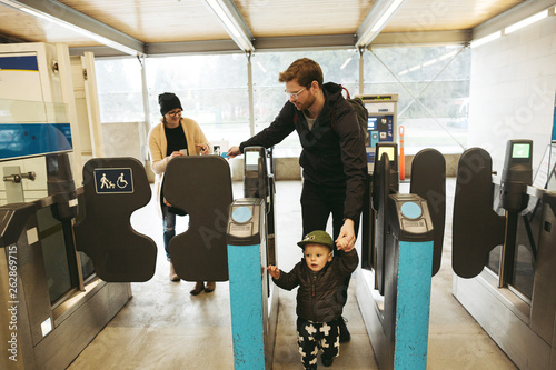 Young family taking bus transit in city together