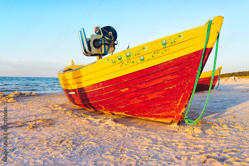 fishing boats on the sandy beach during sunset fishing boats on the sandy beach during sunset