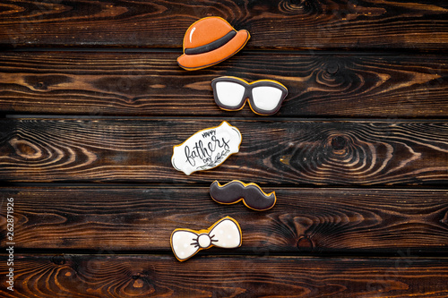 bow tie, moustache, glasses and hat for Happy Father Day party on wooden background top view copy space