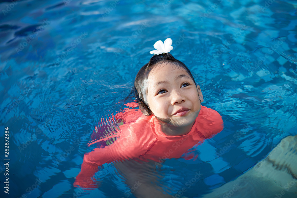 Cute asian little girl playing in the pool Stock Photo | Adobe Stock