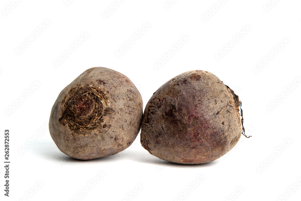 Red beet isolated on white background. Beetroot ready to be cooked. Beetroot lies on the countertop, the concept of cooking and preparing a meal. Dishes for vegetarians. Red beet isolated on white background. Beetroot ready to be cooked. Beetroot lies on the countertop, the concept of cooking and preparing a meal. Dishes for vegetarians.