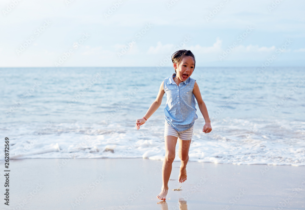 Asian little girl playing excited at the seaside_During the journey Asian little girl playing excited at the seaside_During the journey