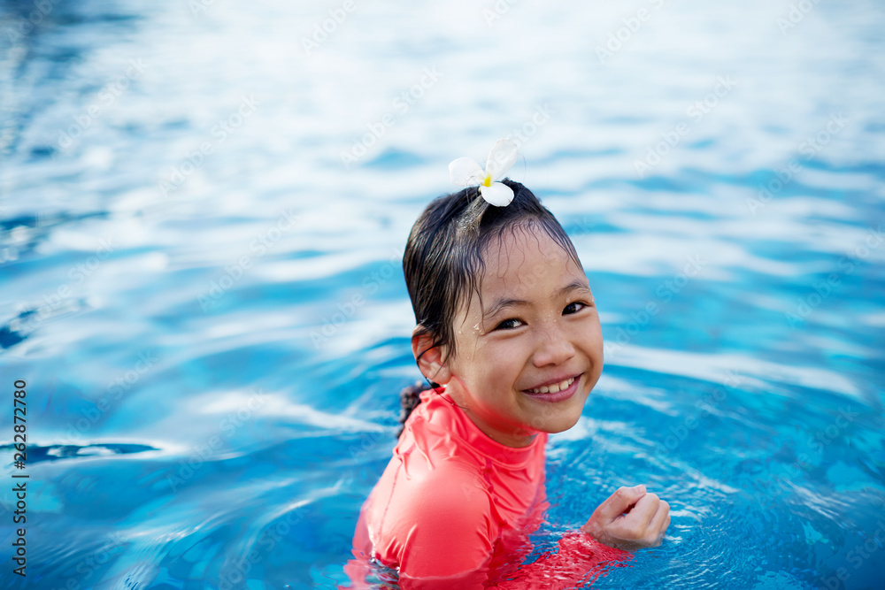 Cute asian little girl playing in the pool Stock Photo | Adobe Stock