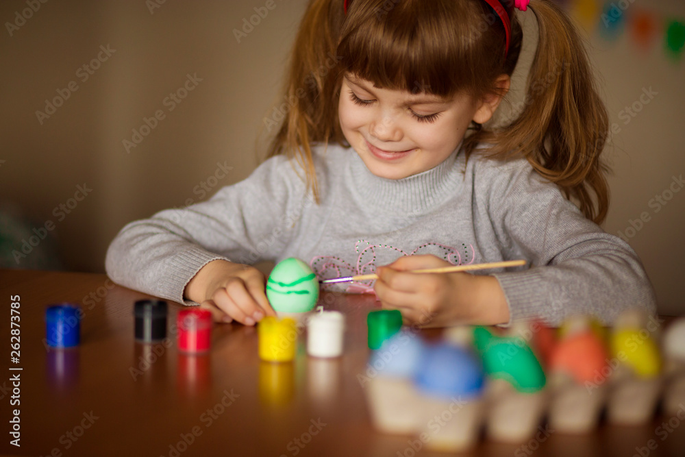 Happy easter. Little girl painter painted eggs. Kid preparing for Easter. Painted hand. Art and craft concept. Traditional spring holiday food Happy easter. Little girl painter painted eggs. Kid preparing for Easter. Painted hand. Art and craft concept. Traditional spring holiday food