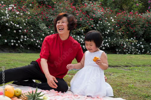 happy senior woman with little girl outdoor photo