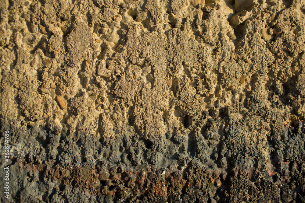 The texture of the cement wall. The concrete wall is stained with paint. Detail of graffiti. The texture of the cement wall. The concrete wall is stained with paint. Detail of graffiti.
