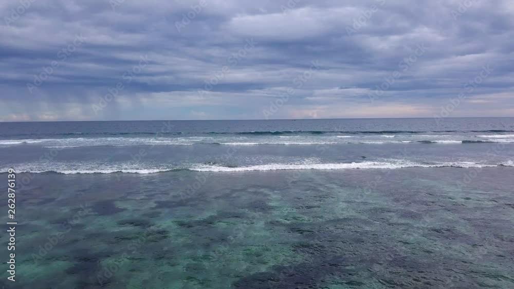 Long surf waves on the coastline of Melasti beach, aerial view. Long surf waves on the coastline of Melasti beach, aerial view.