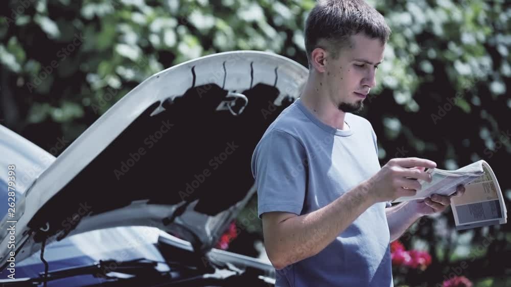 Man reading car manual