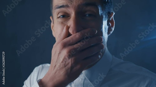 Scared businessman is frightened and afraid covers his face with hand