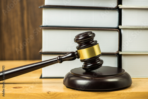 gavel justice hammer on wood table with  book shelf background