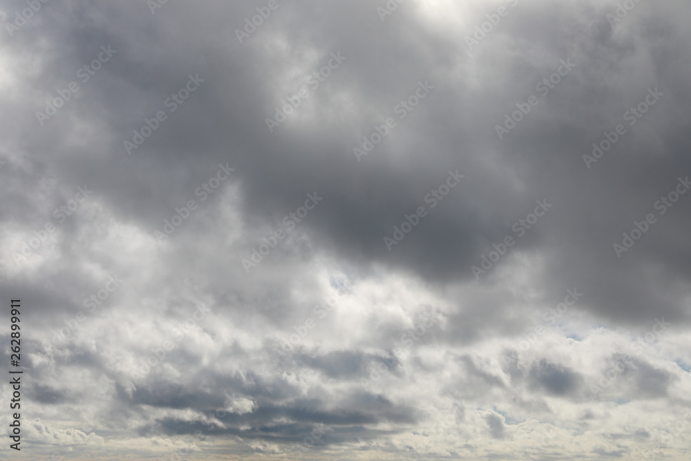 Dramatic sky with grey and white clouds to horizon