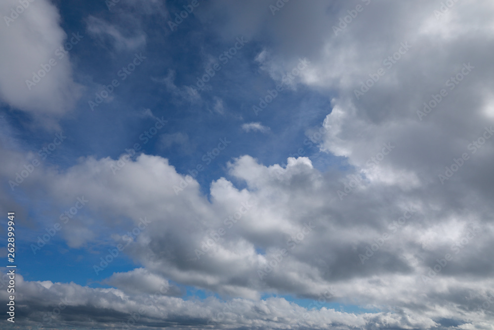blue sky with white and grey clouds to horizon blue sky with white and grey clouds to horizon